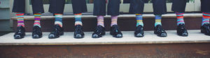 People in suits wearing colourful socks