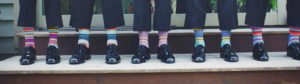 People in suits with colourful socks
